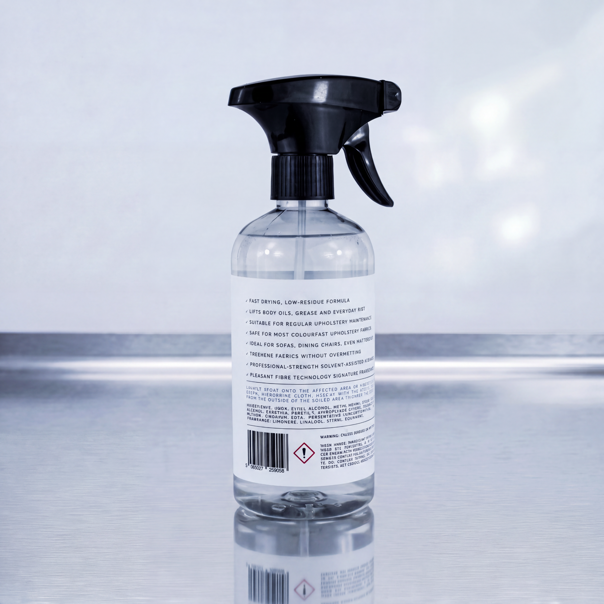 A clear plastic spray bottle with a black trigger sprayer, shown from the back, containing a transparent liquid. The product is photographed on a reflective gray surface against a light gray background.